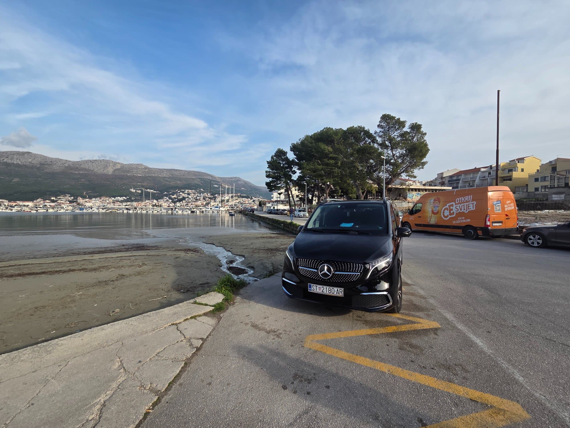 Mercedes V-Class at Croatian harbor with mountains in background